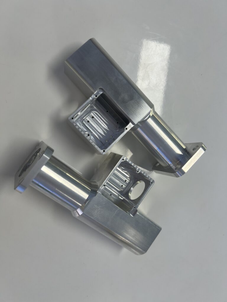 Aluminum mounting housings with rectangular pockets, cylindrical extensions and flanges